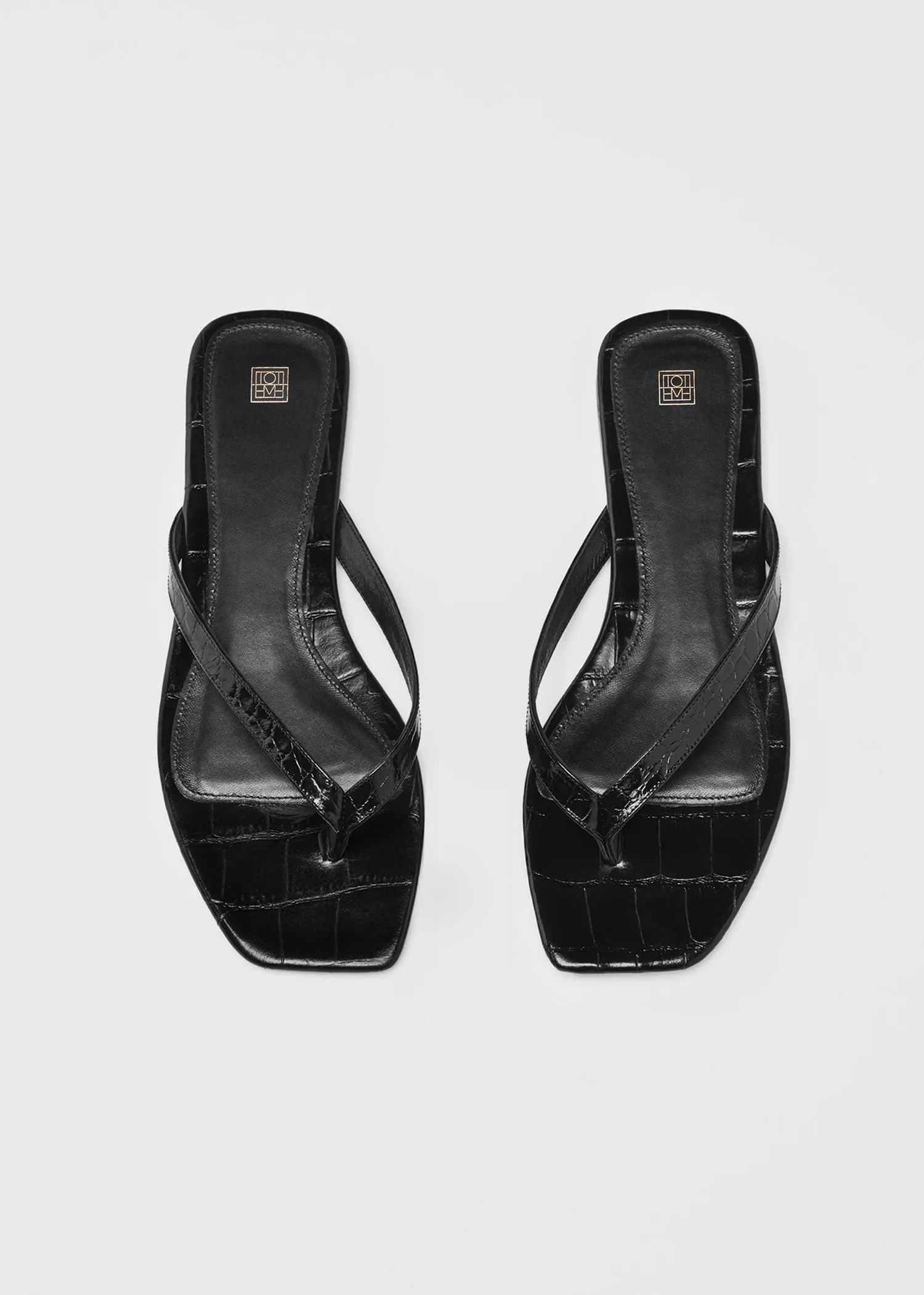 Croco-embossed flip flops black